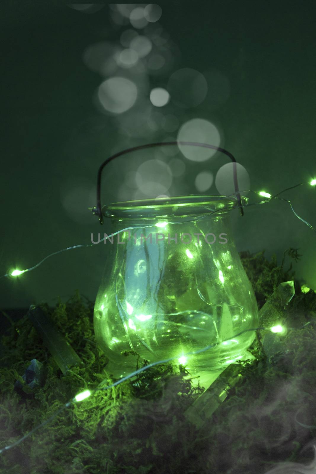 Magic cauldron, green background, moss, firefly, fog smoke bokeh close-up