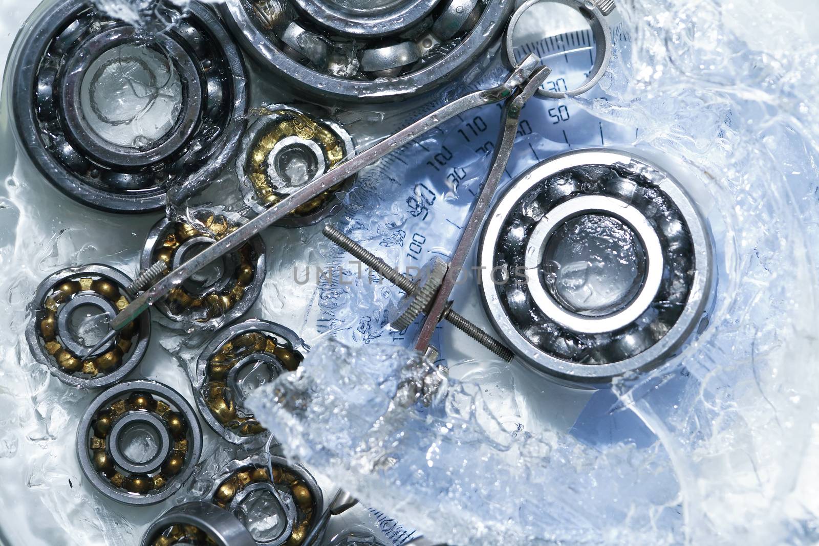 Machinery concept. Closeup set of ball bearings under frozen water