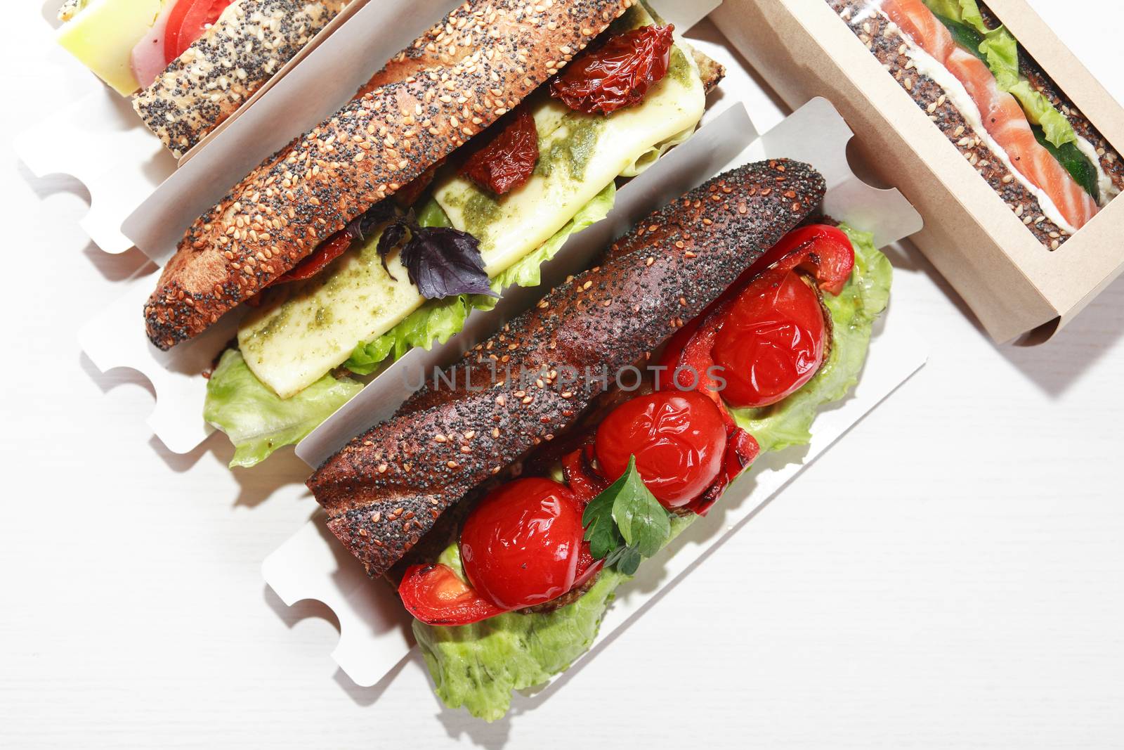 Set of various takeaway sandwiches in boxes on white background