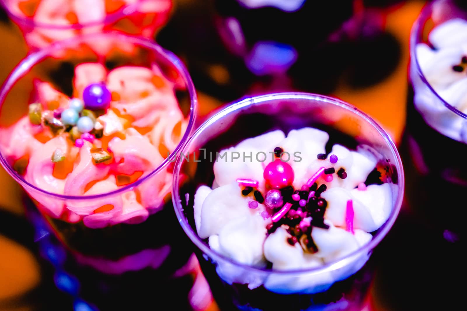 glasses with dessert-cream and sprinkles