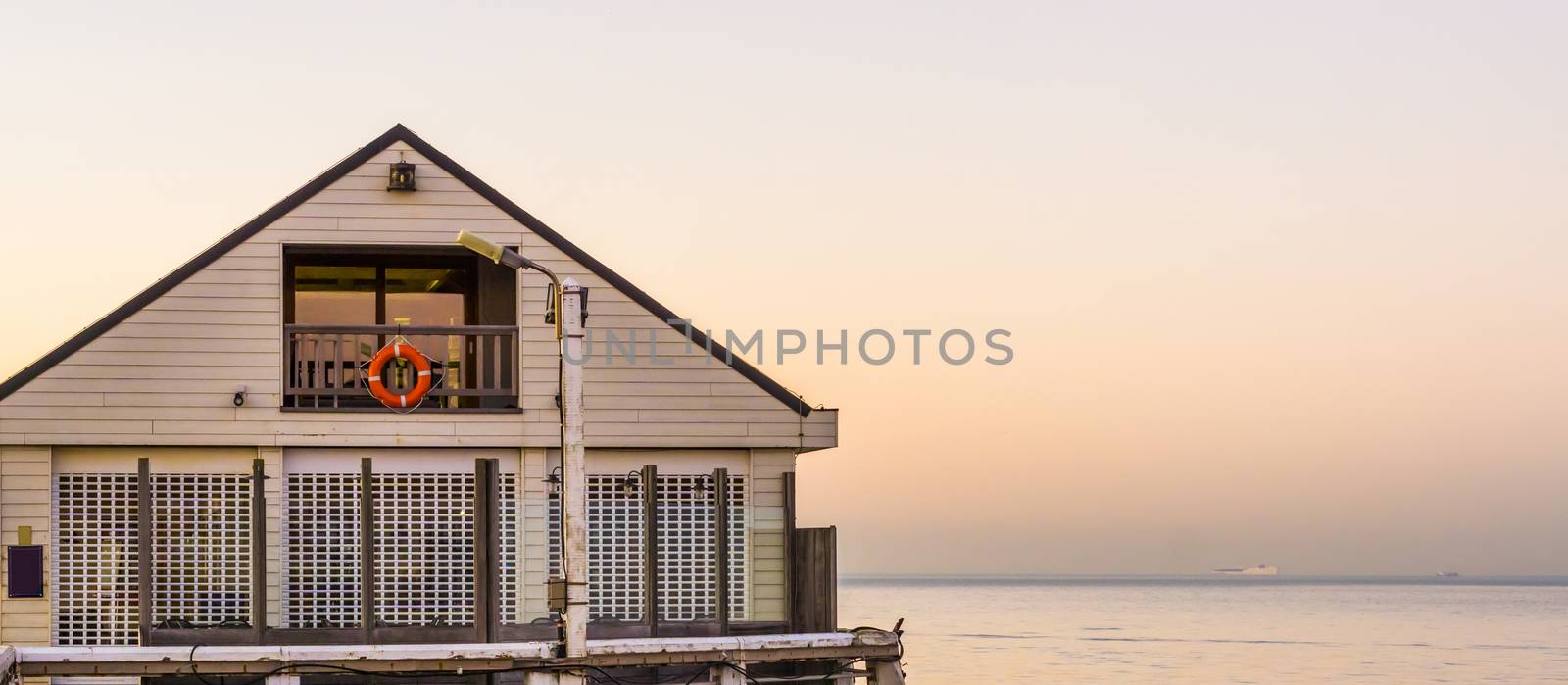 white beach house on the pier of Blankenberge, Belgium, Architecture of the Belgian coast at sunset