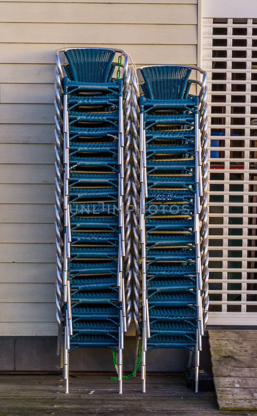 stacked chairs next to a closed rolling shutter, closing time in the catering industry