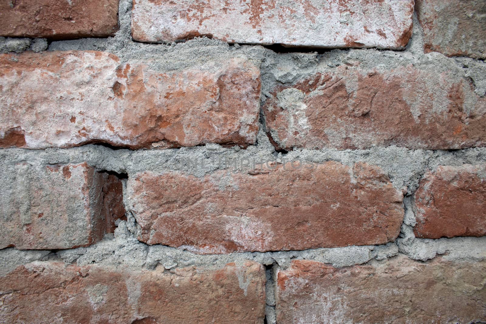 Destroyed brick wall, red texture grunge background