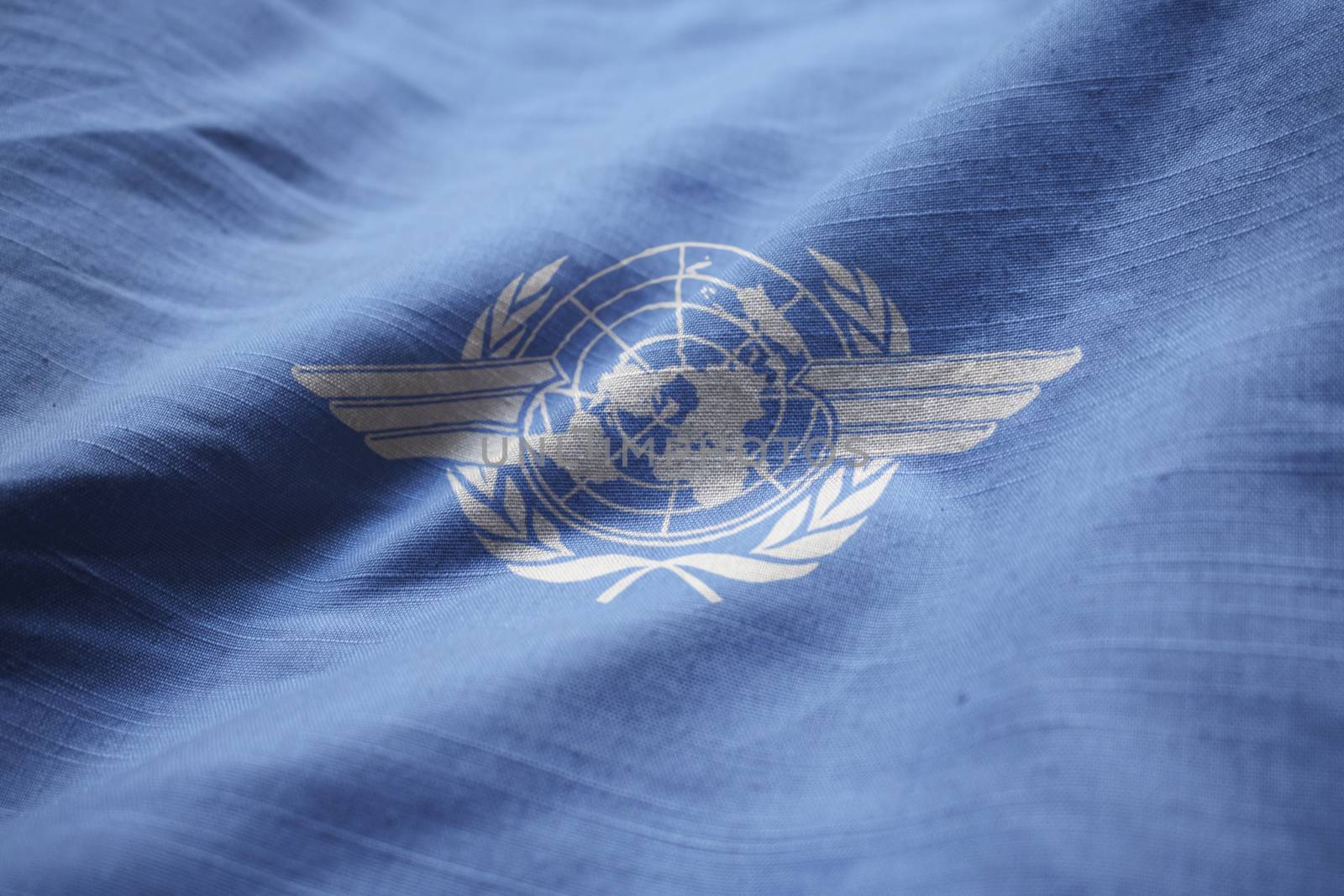 Closeup of Ruffled International Civil Aviation Organization Flag, ICAO Flag Blowing in Wind