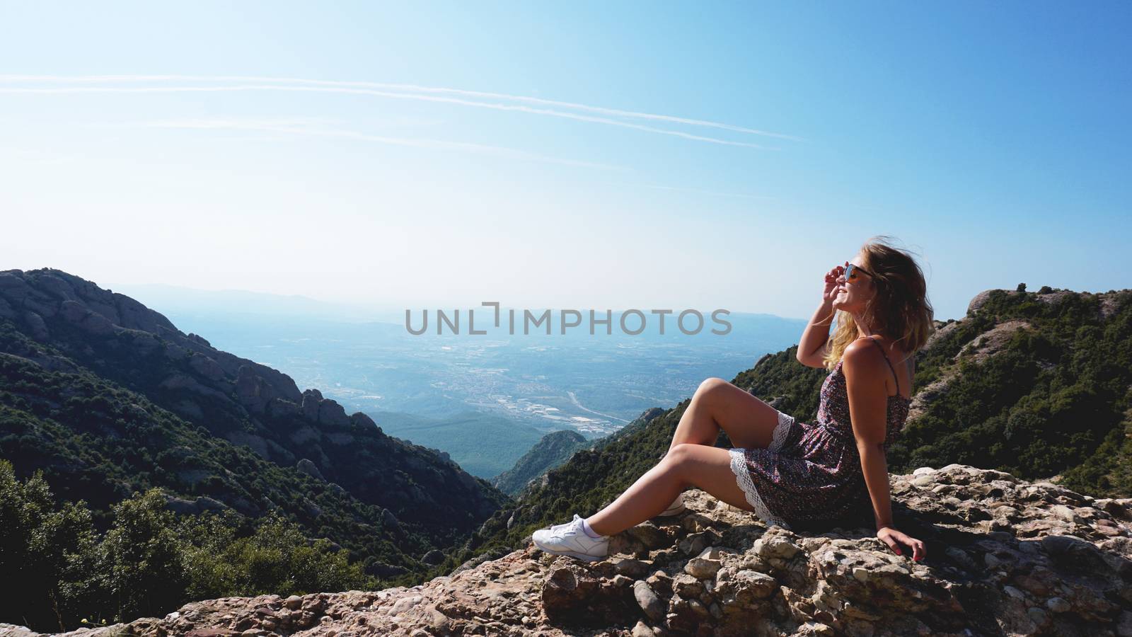 Young happy woman enjoying the magnifisent view of Montserrat Mountains