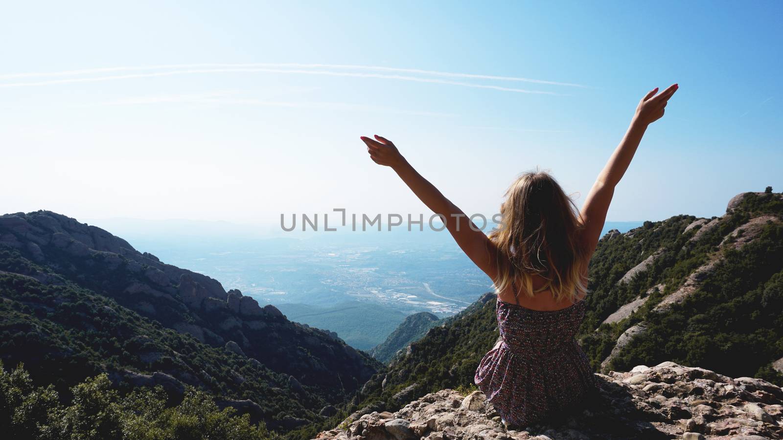 Young happy woman enjoying the magnifisent view of Montserrat Mountains