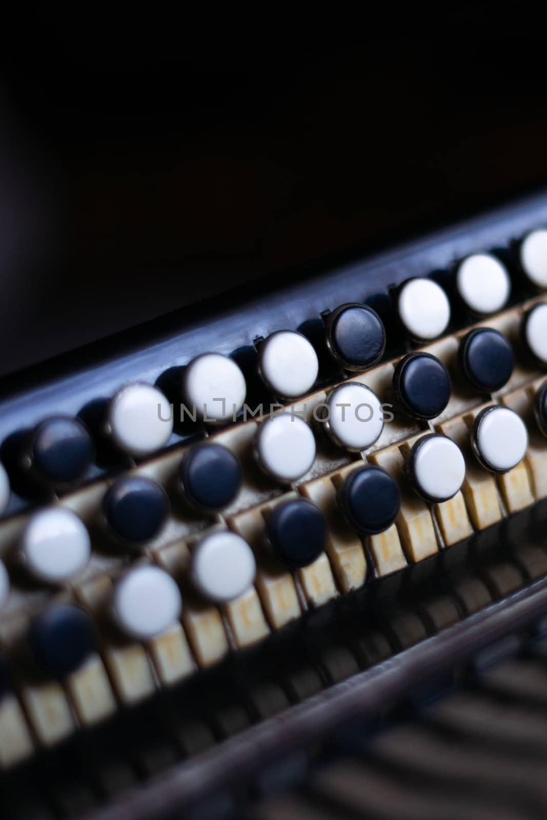 The old rare accordion buttons close up view. Low light photo. by alexsdriver