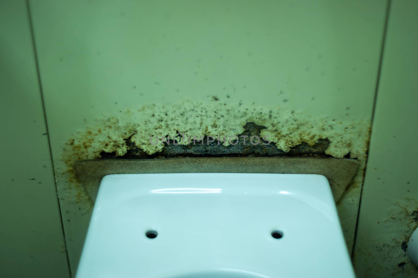 Dirty terrible toilet in a public toilet. Plating deteriorated from moisture and urine