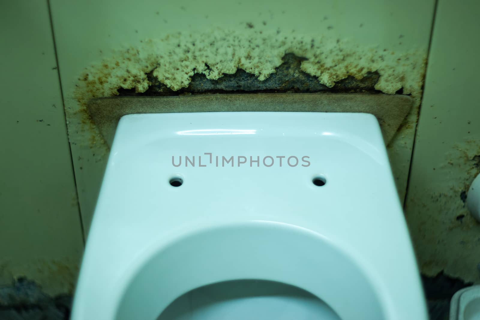 Dirty terrible toilet in a public toilet. Plating deteriorated from moisture and urine