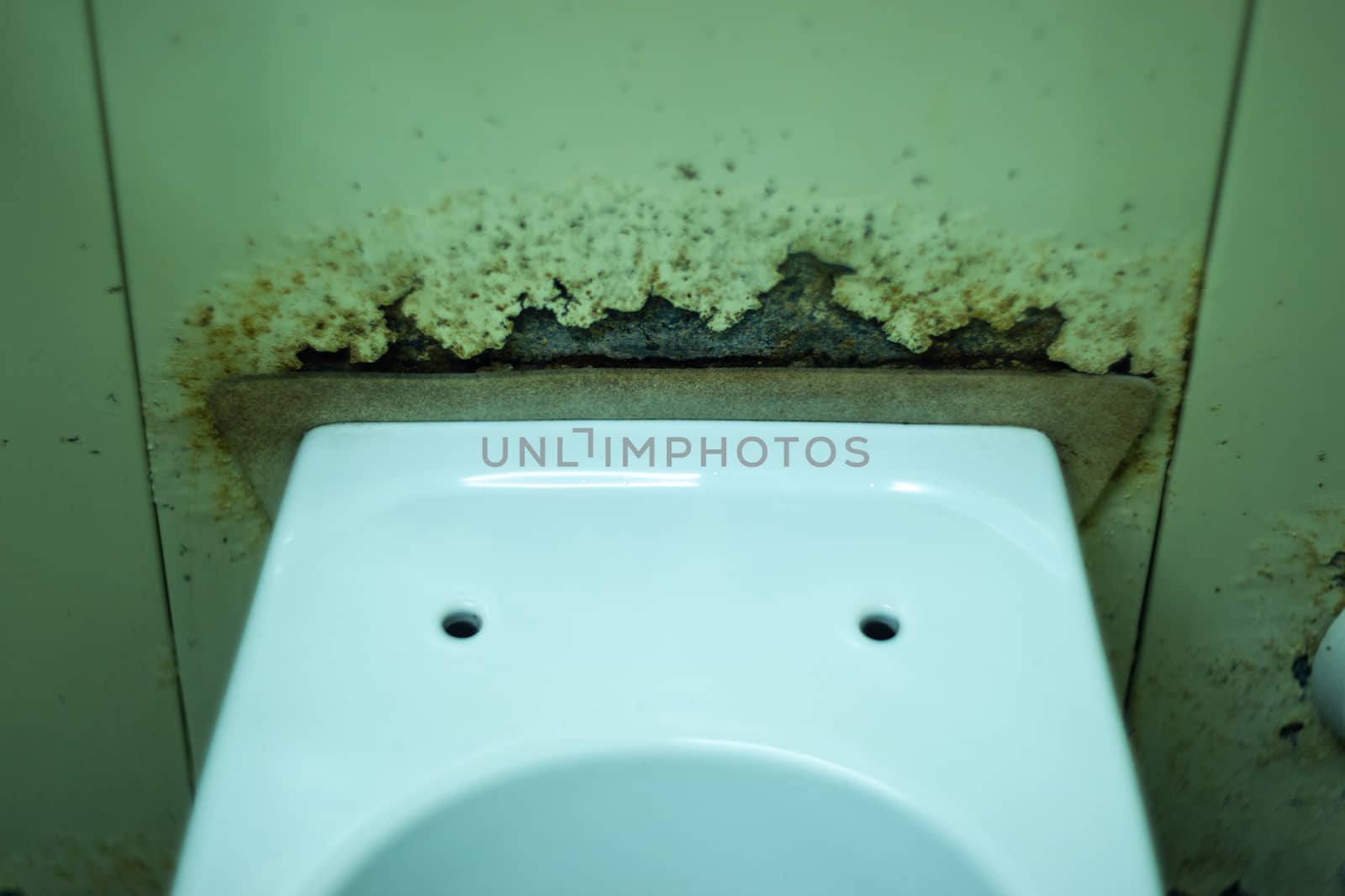 Dirty terrible toilet in a public toilet. Plating deteriorated from moisture and urine