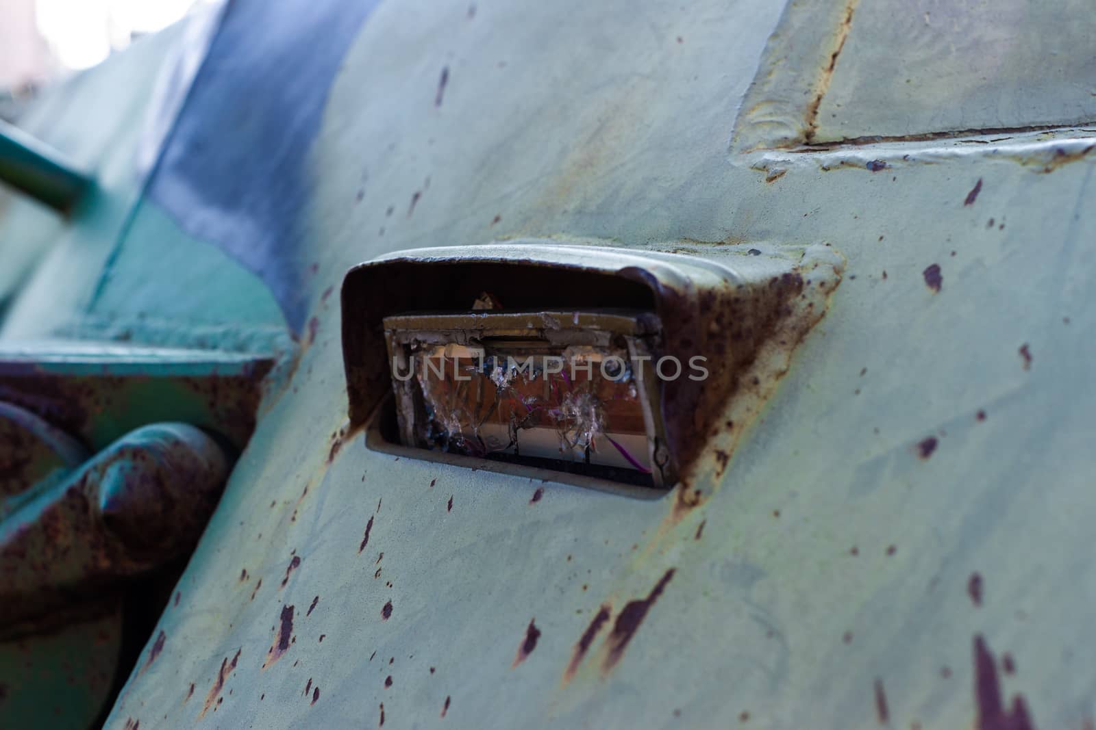 Damaged body of a military armored infantry. Parts of looking triplex device. Outdoor military vehicles museum. Armor is damaged at the battlefield.