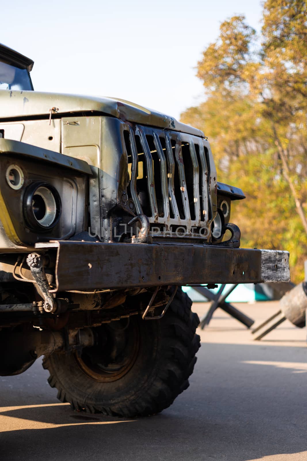 Camouflage military truck with rocket launcher. Outdoor military vehicles museum. Armor is damaged at the battlefield.