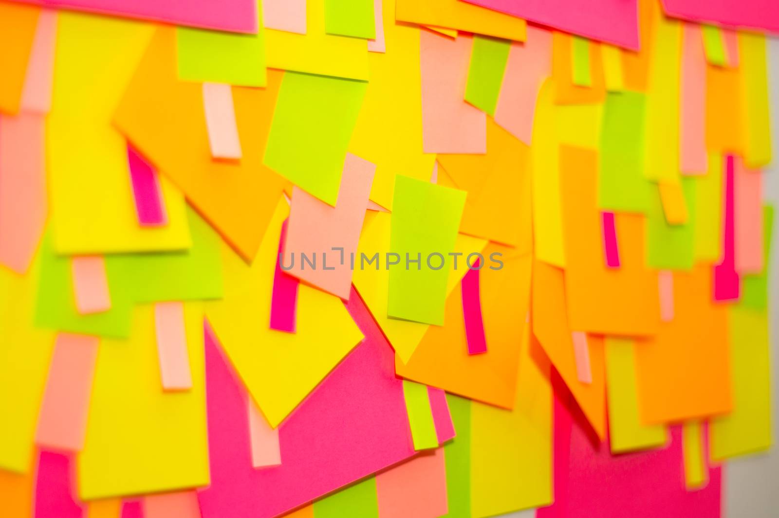 Bright multi-colored stickers on the office white board.