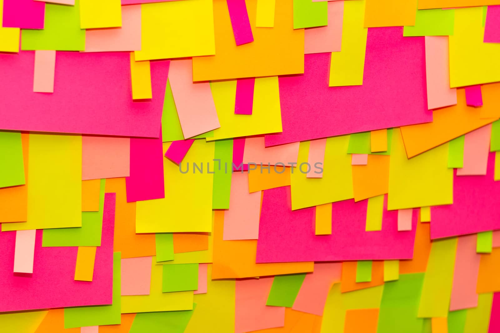 Bright multi-colored stickers on the office white board.