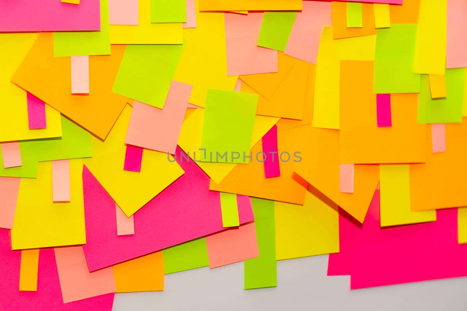 Bright multi-colored stickers on the office white board.