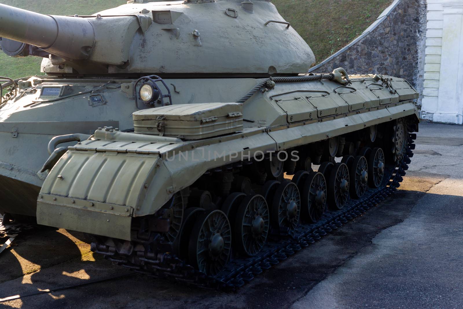 Parts of the hull of the old tank in the museum of military vehicles outdoor in the open air. Gun and truck parts closeup view.