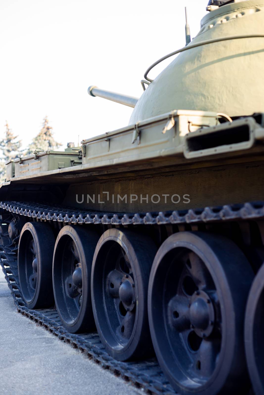 Parts of the hull of the armored old tank. In front and back of tank stays many different tanks. Parts closeup. Military equipment outdoor open air museum. by alexsdriver