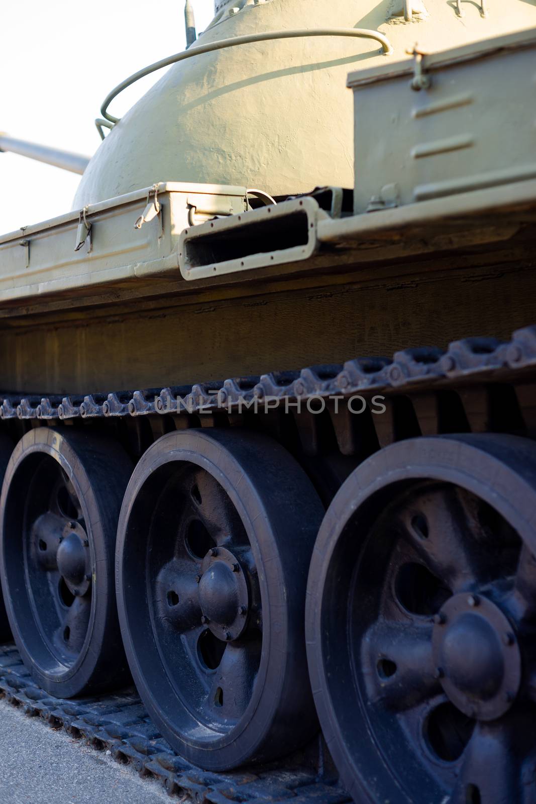 Parts of the hull of the armored old tank. In front and back of tank stays many different tanks. Parts closeup. Military equipment outdoor open air museum. by alexsdriver