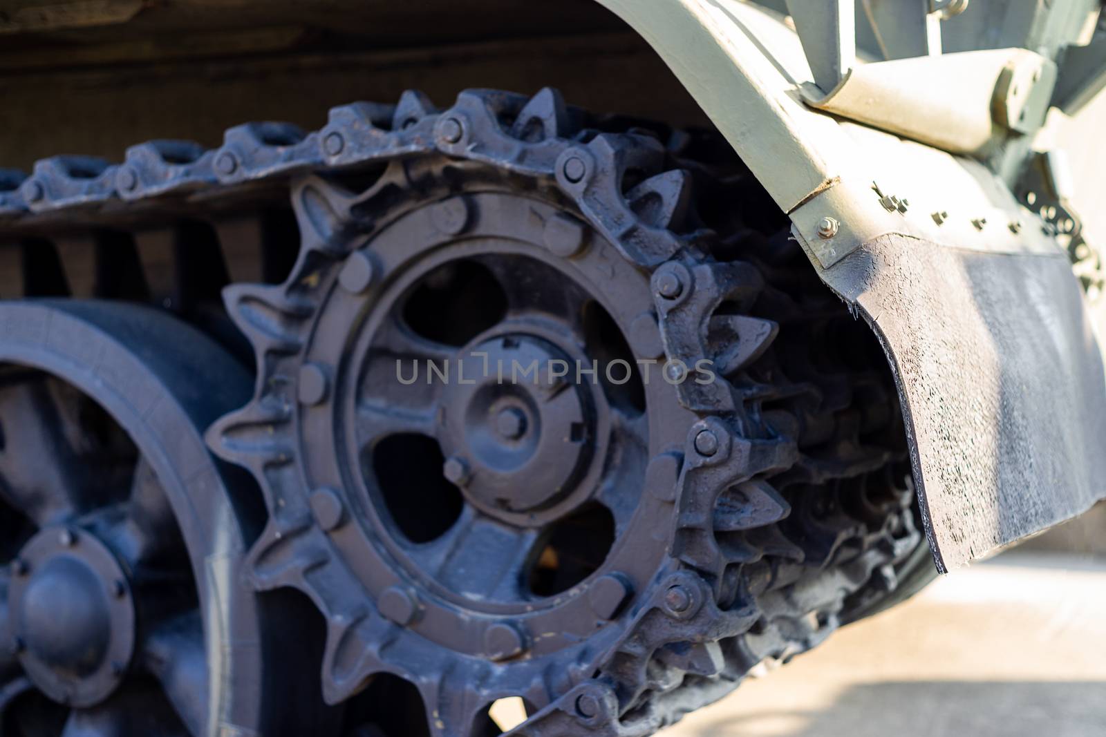 Parts of the hull of the armored old tank. In front and back of tank stays many different tanks. Parts closeup. Military equipment outdoor open air museum. by alexsdriver