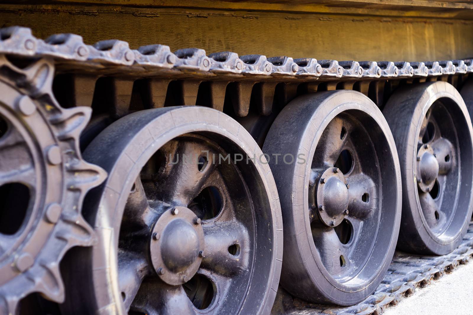 Parts of the hull of the armored old tank. In front and back of tank stays many different tanks. Parts closeup. Military equipment outdoor open air museum.