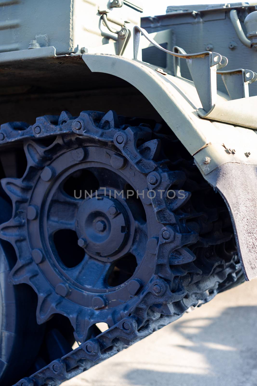 Parts of the hull of the armored old tank. In front and back of tank stays many different tanks. Parts closeup. Military equipment outdoor open air museum.