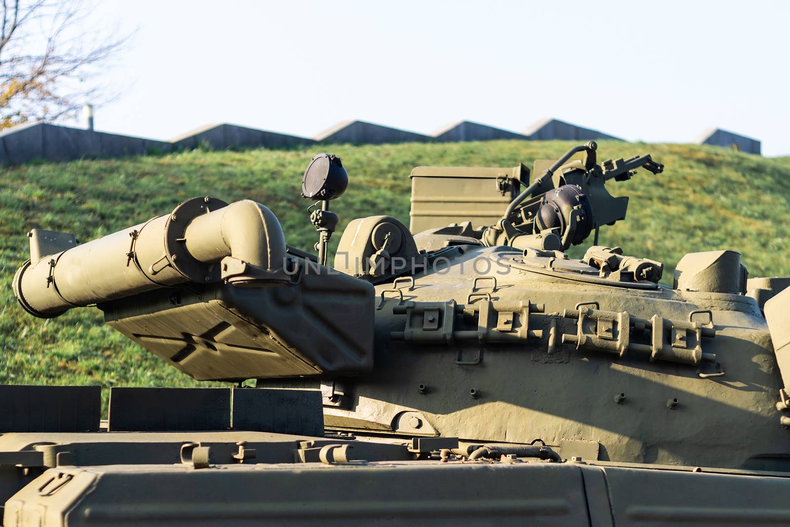 Parts of the hull of the armored old tank. In front and back of tank stays many different tanks. Parts closeup. Military equipment outdoor open air museum.