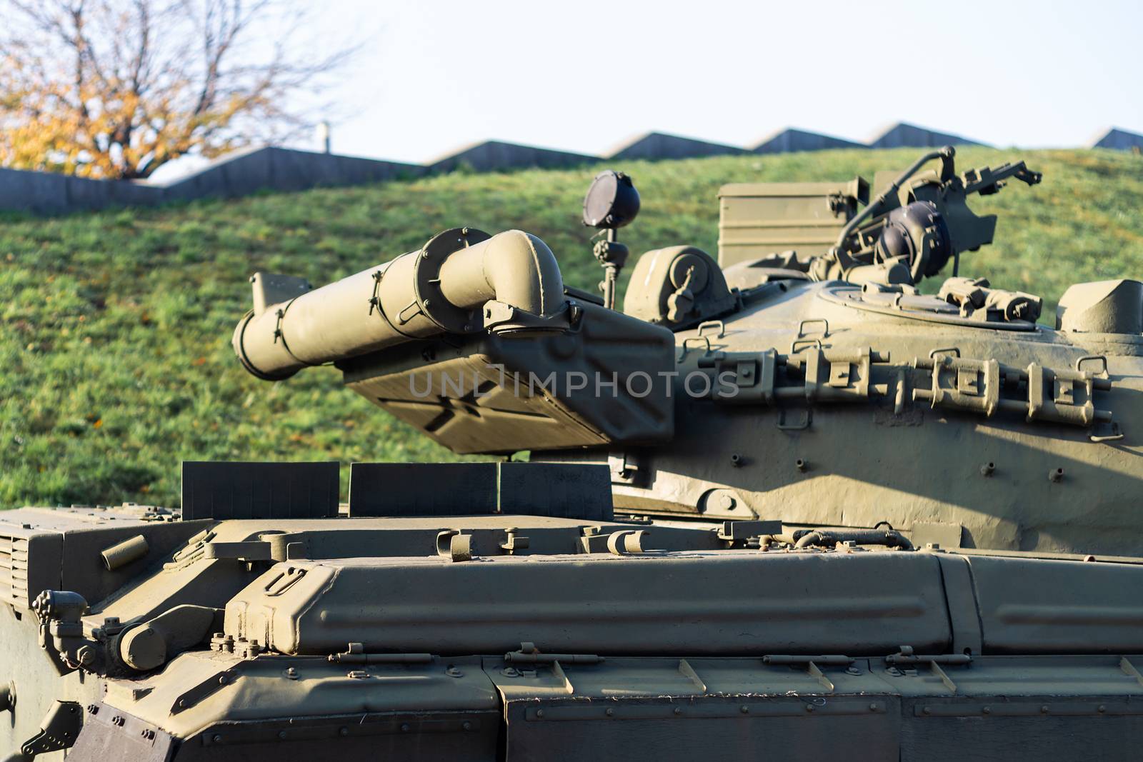 Parts of the hull of the armored old tank. In front and back of tank stays many different tanks. Parts closeup. Military equipment outdoor open air museum.