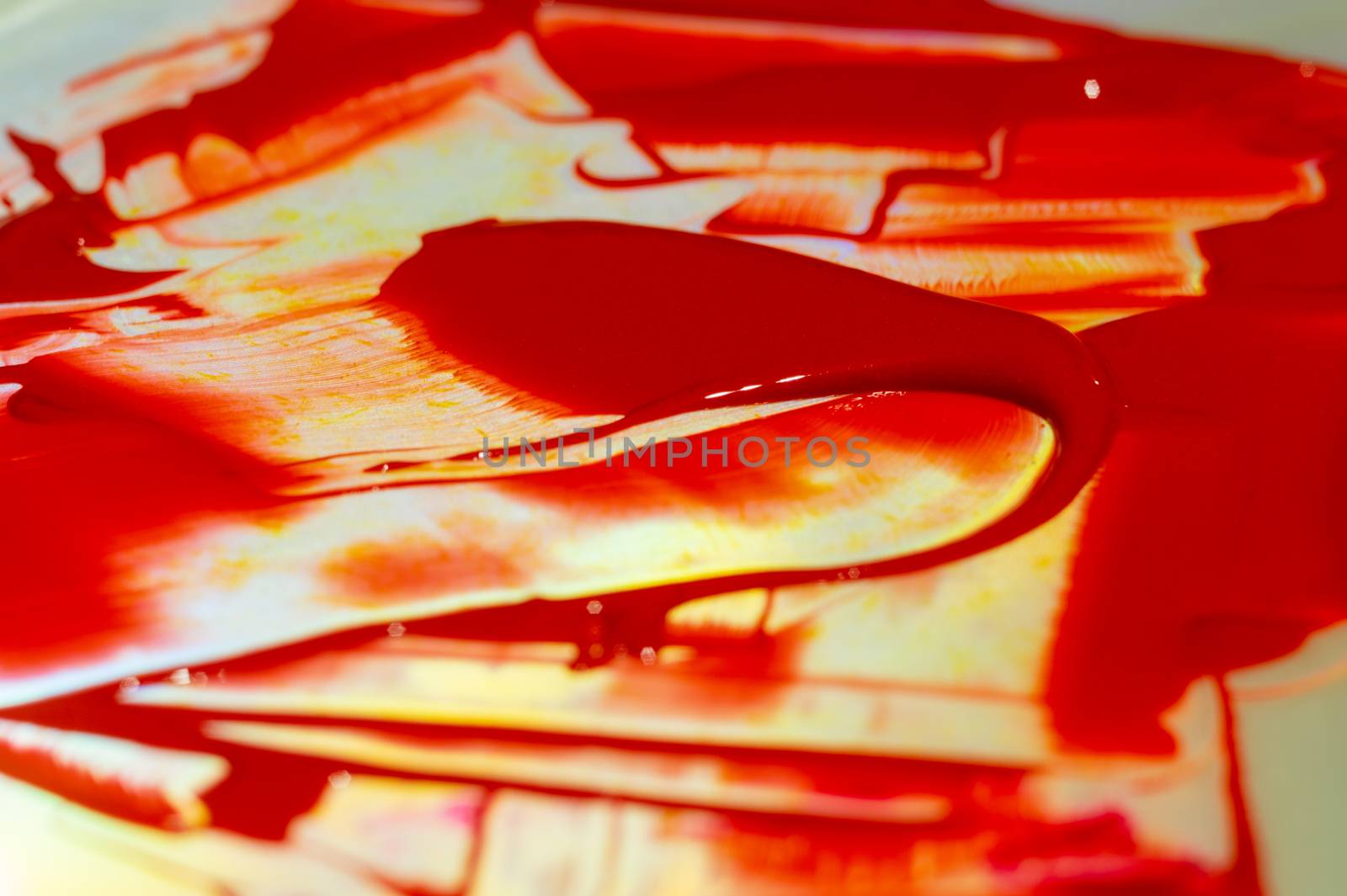 Hue red acrylic paint on glare table. Palette on table. Artist life. by alexsdriver