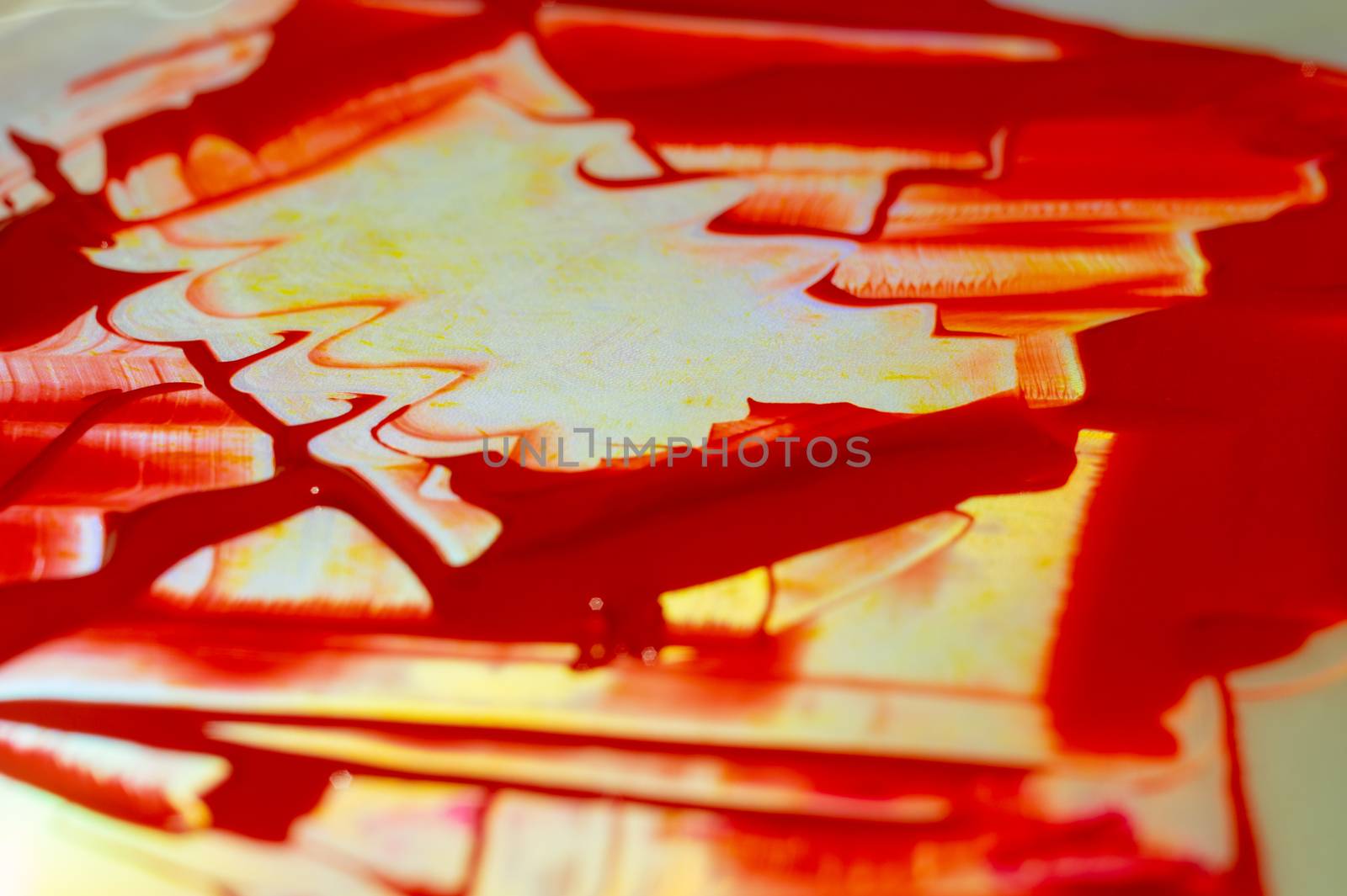 Hue red acrylic paint on glare table. Palette on table. Artist life.