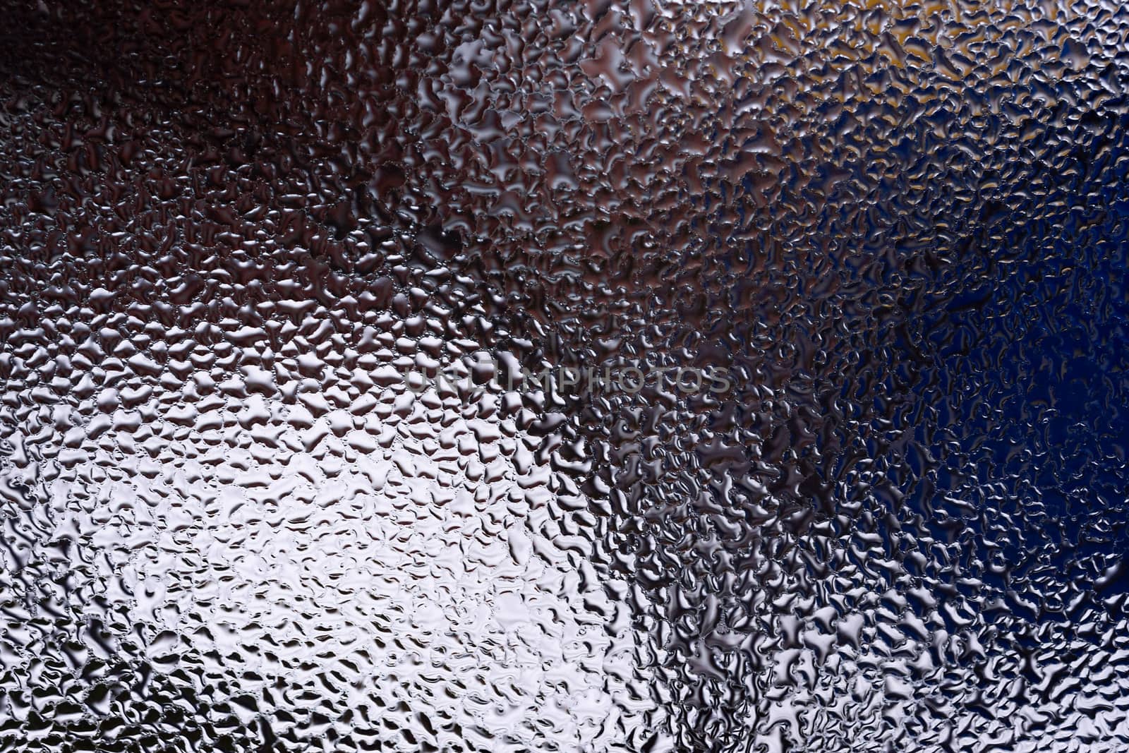 Water drops on glass window close up with blurred background. Drops in macro. Condensate on window closeup. Wet air.
