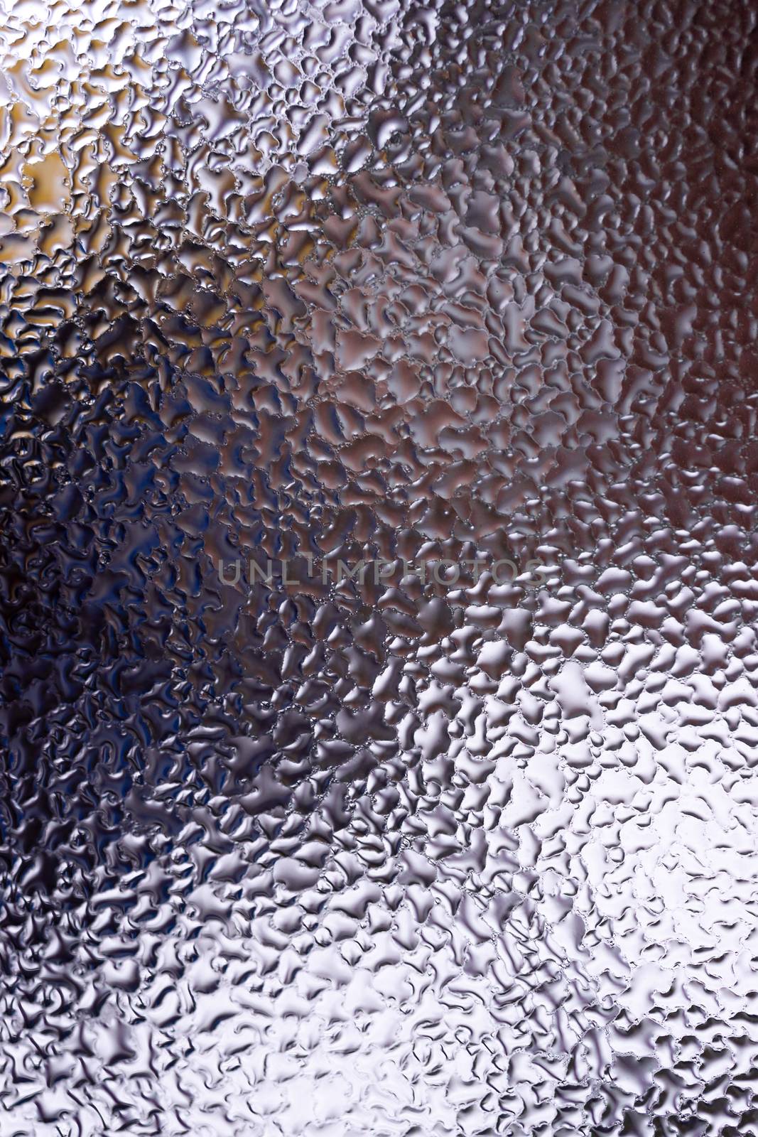 Water drops on glass window close up with blurred background. Drops in macro. Condensate on window closeup. Wet air.