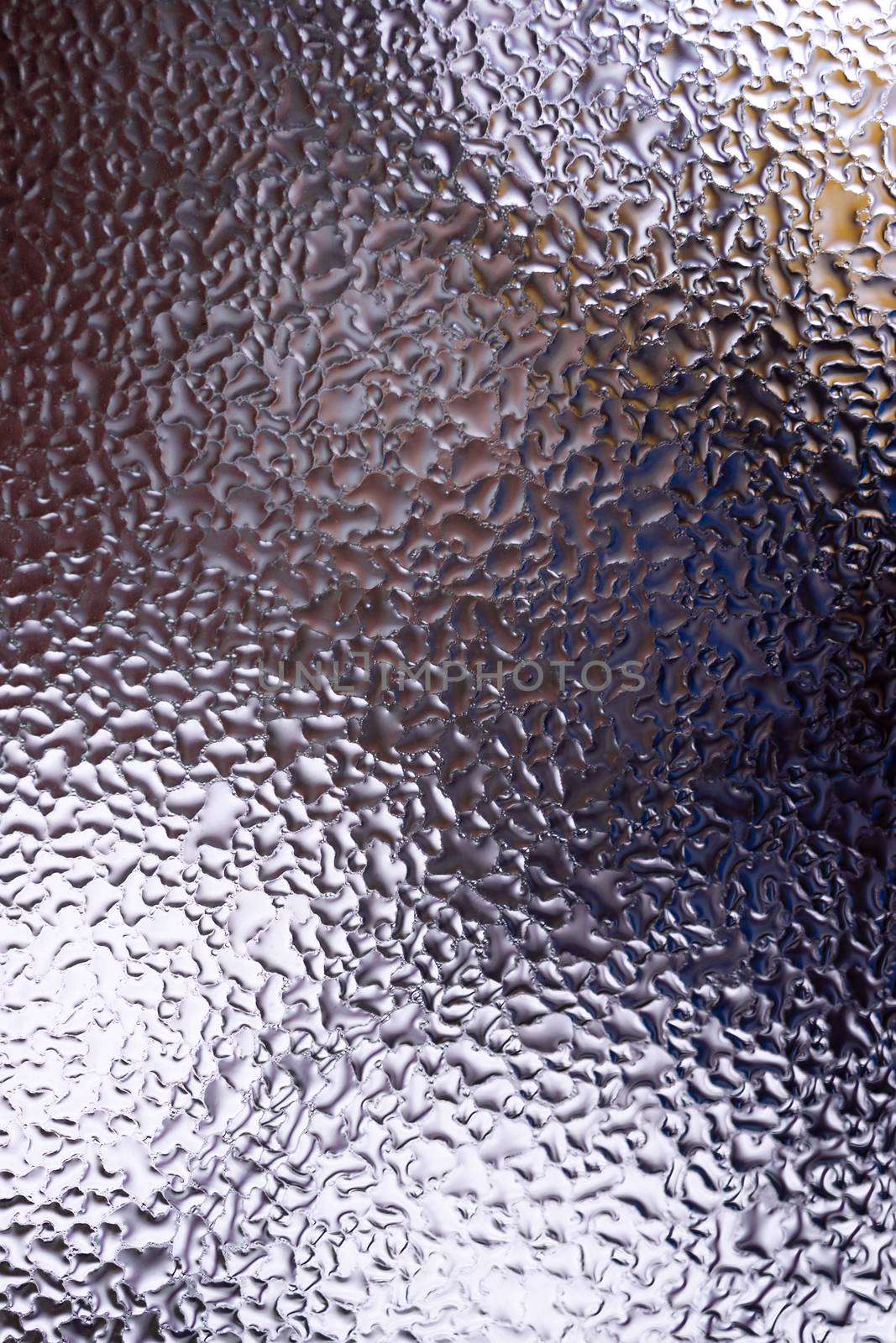 Water drops on glass window close up with blurred background. Drops in macro. Condensate on window closeup. Wet air.