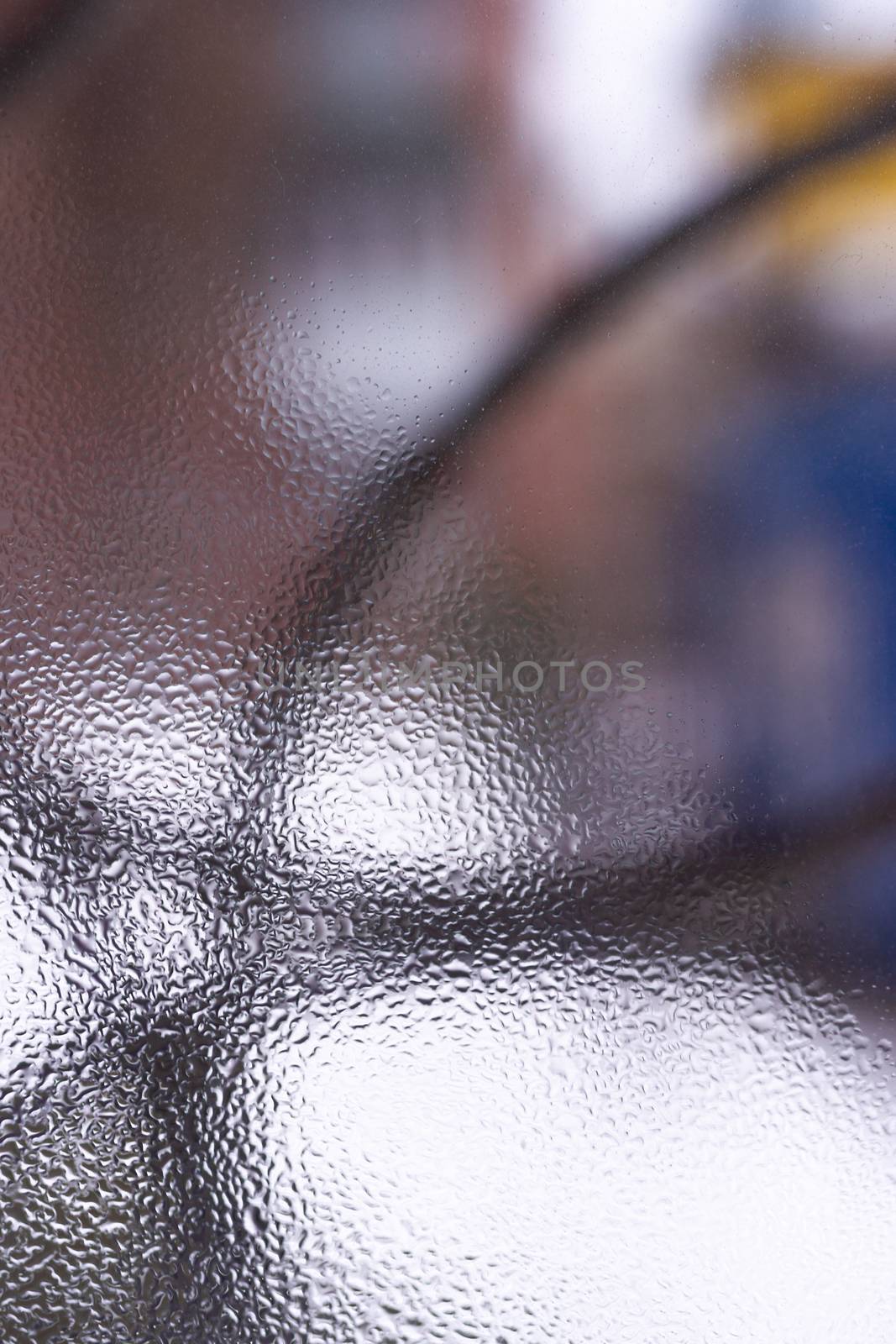 Water drops on glass window close up with blurred background. Drops in macro. Condensate on window closeup. Wet air.
