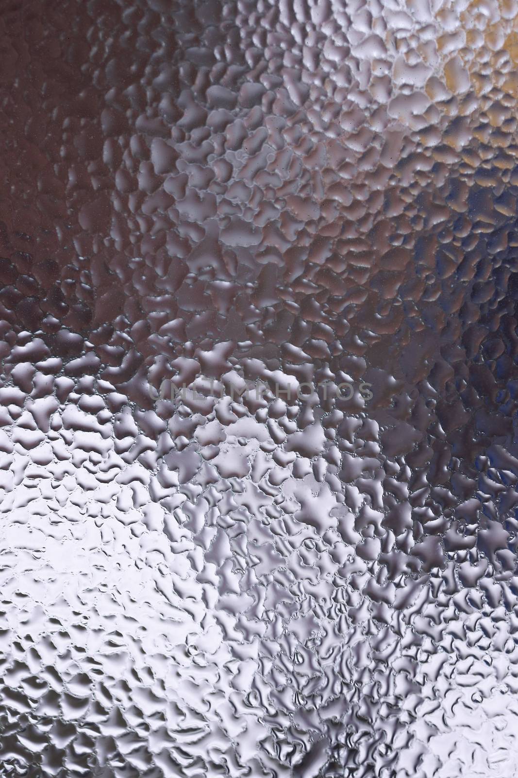 Water drops on glass window close up with blurred background. Drops in macro. Condensate on window closeup. Wet air.