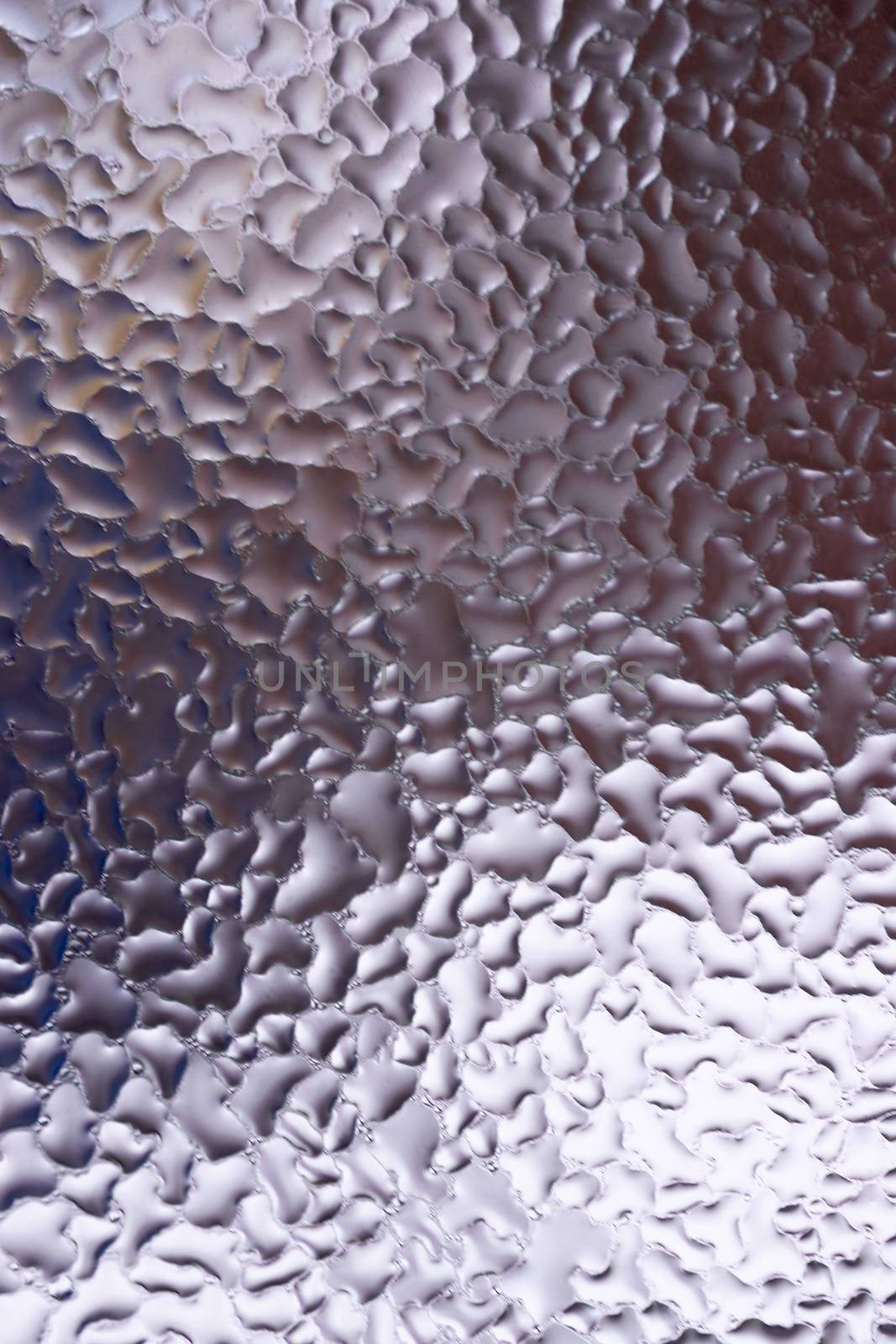 Water drops on glass window close up with blurred background. Drops in macro. Condensate on window closeup. Wet air.