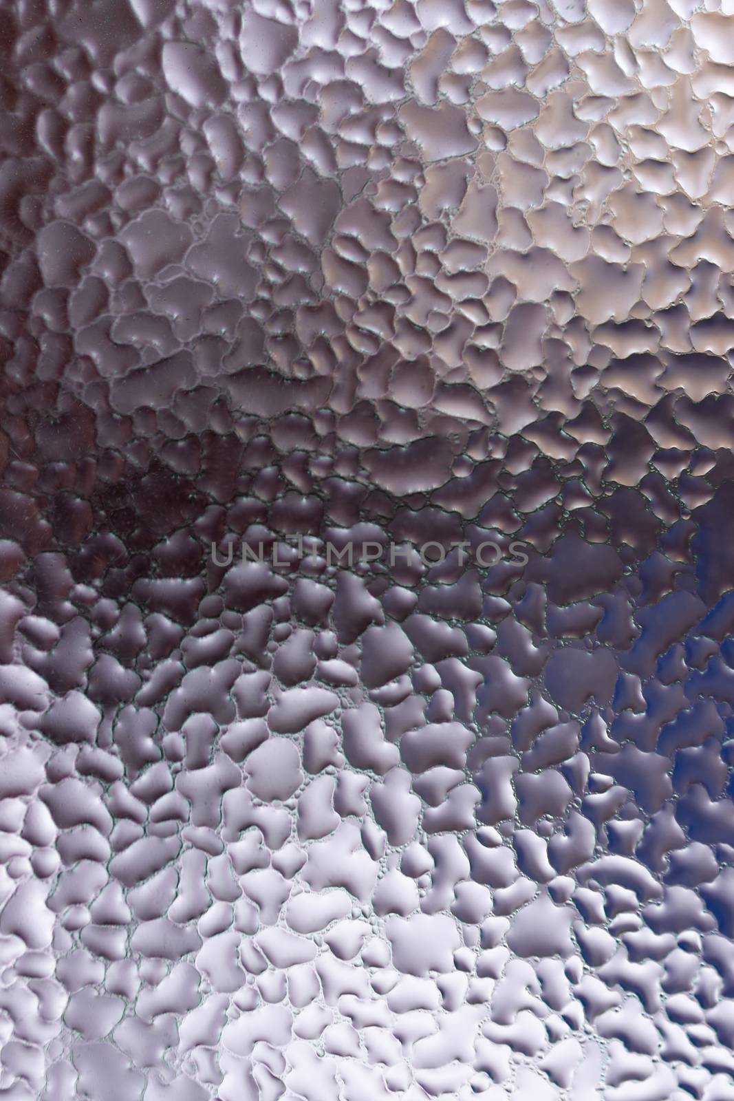 Water drops on glass window close up with blurred background. Drops in macro. Condensate on window closeup. Wet air.
