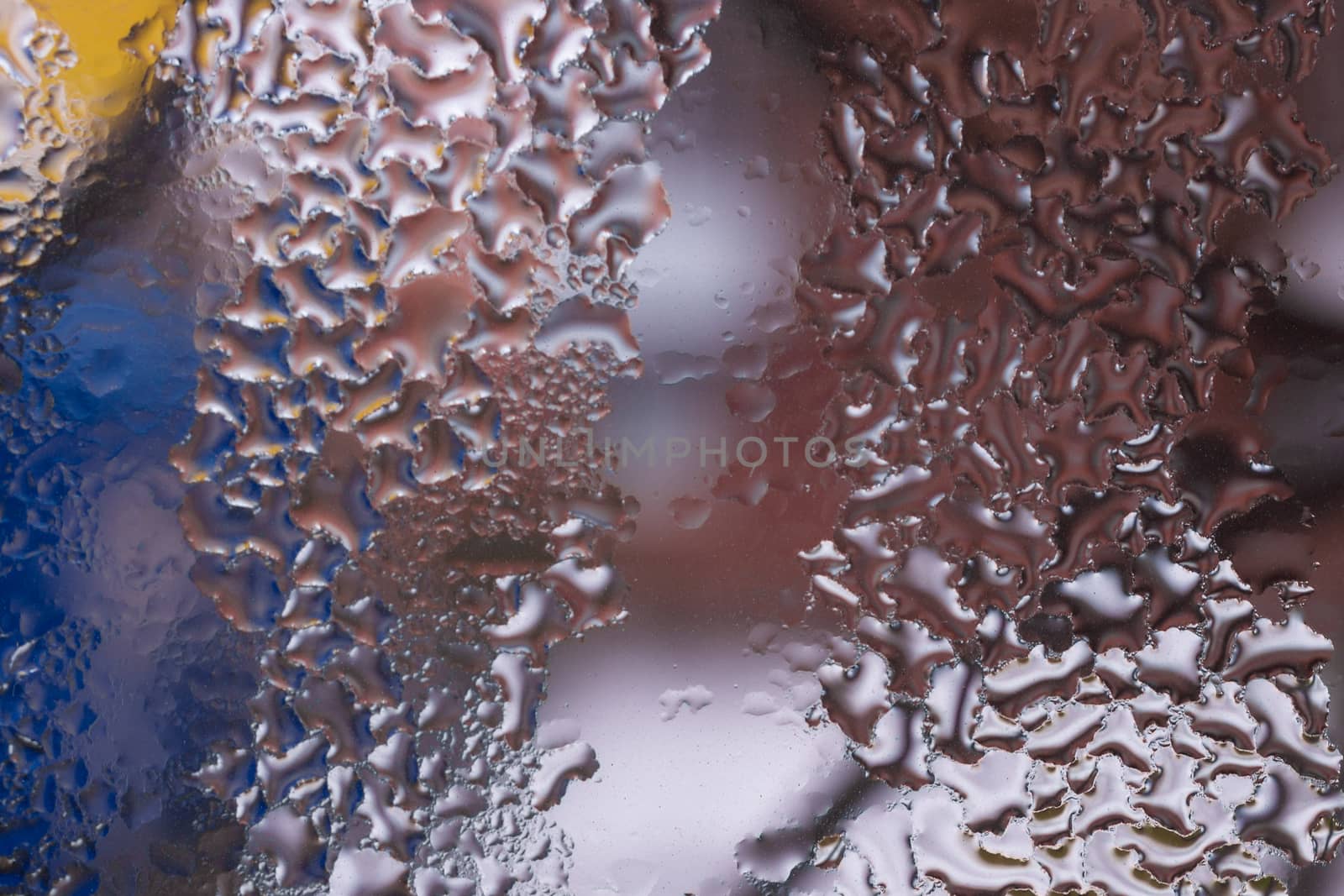 Water drops on glass window close up with blurred background. Drops in macro. Condensate on window closeup. Wet air.