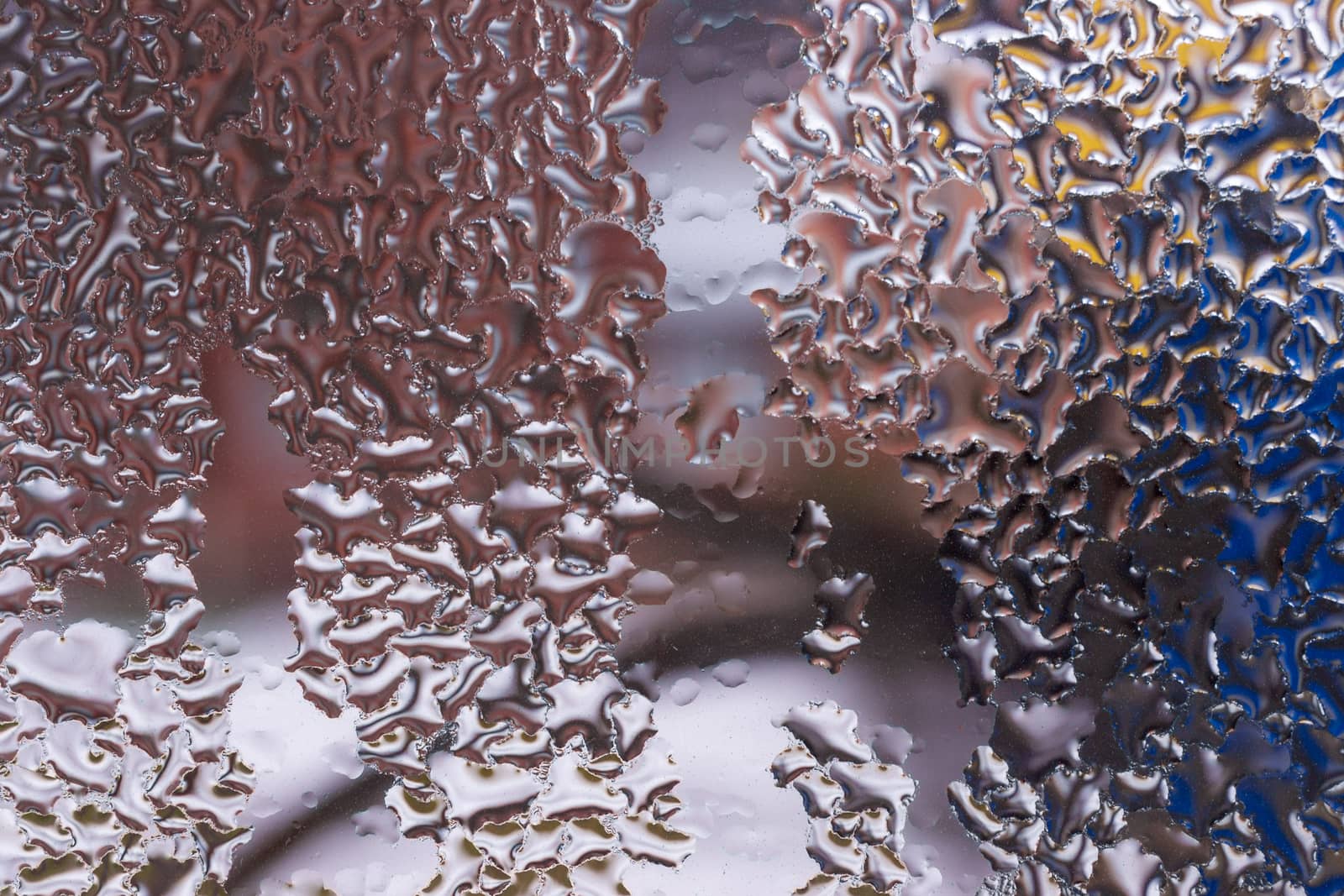 Water drops on glass window close up with blurred background. Drops in macro. Condensate on window closeup. Wet air.