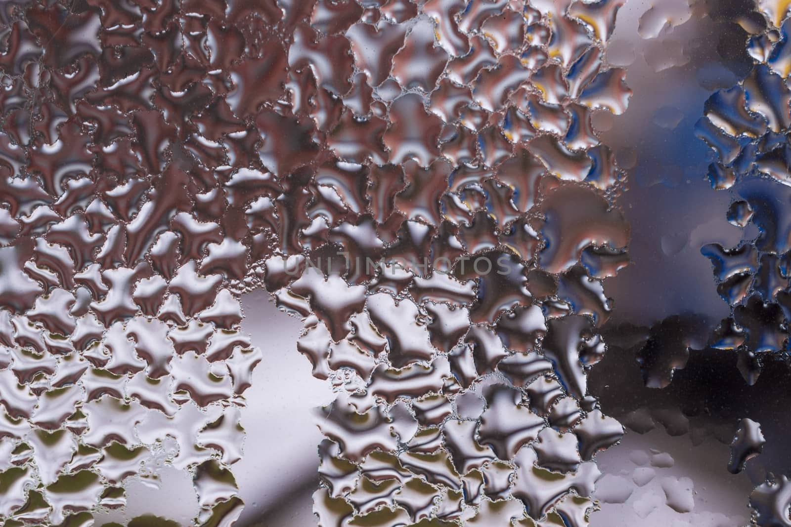Water drops on glass window close up with blurred background. Drops in macro. Condensate on window closeup. Wet air.