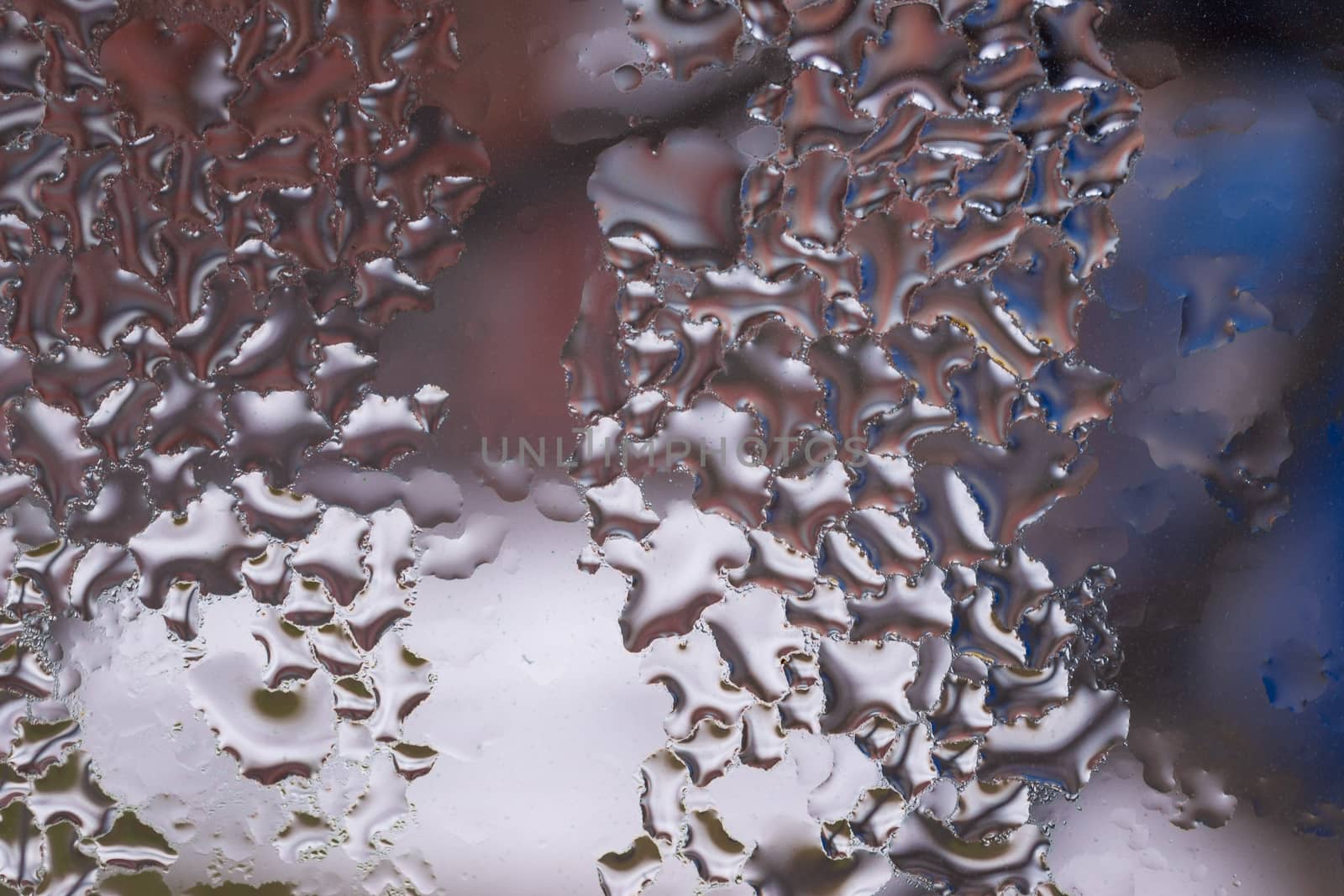 Water drops on glass window close up with blurred background. Drops in macro. Condensate on window closeup. Wet air.