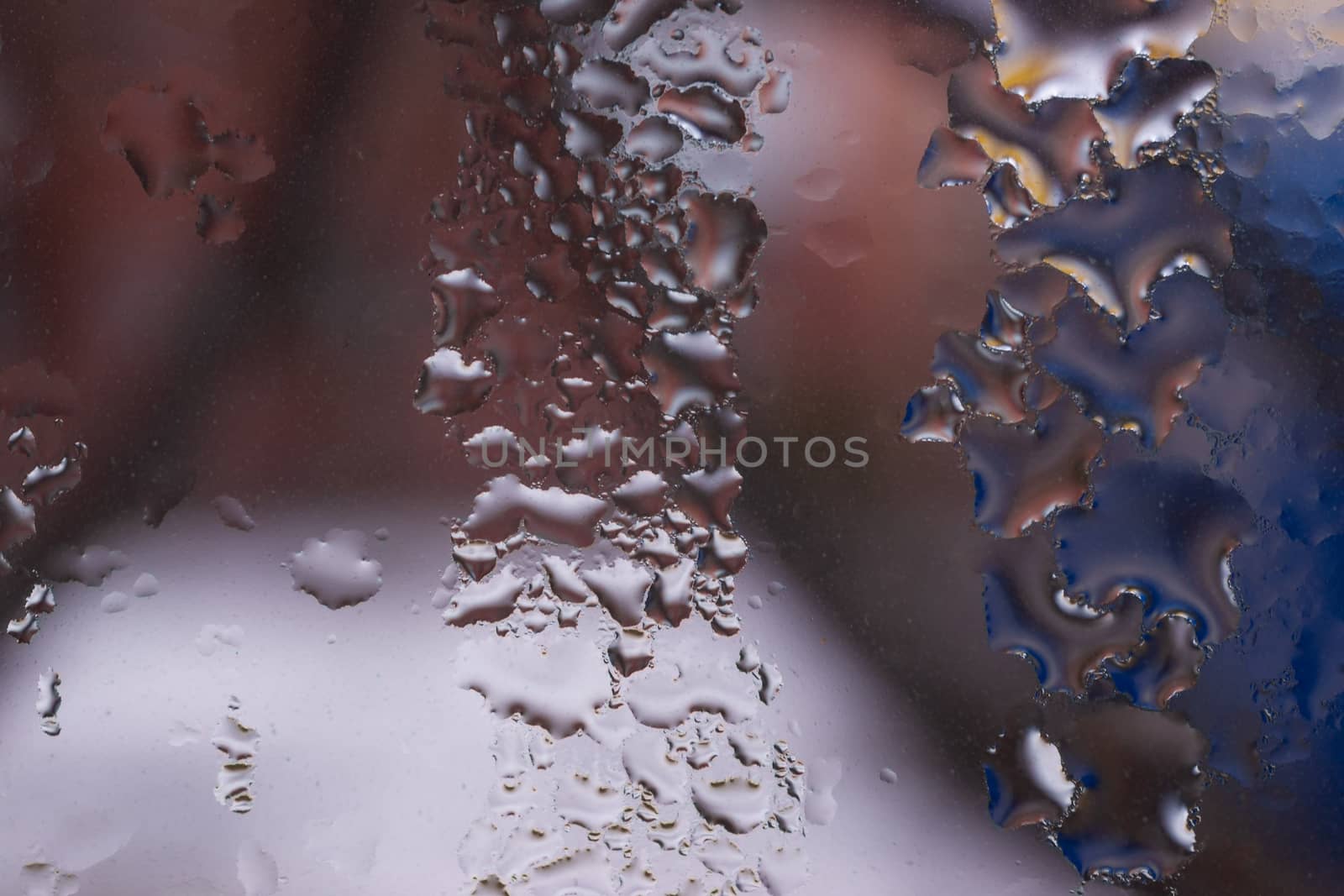 Water drops on glass window close up with blurred background. Drops in macro. Condensate on window closeup. Wet air.