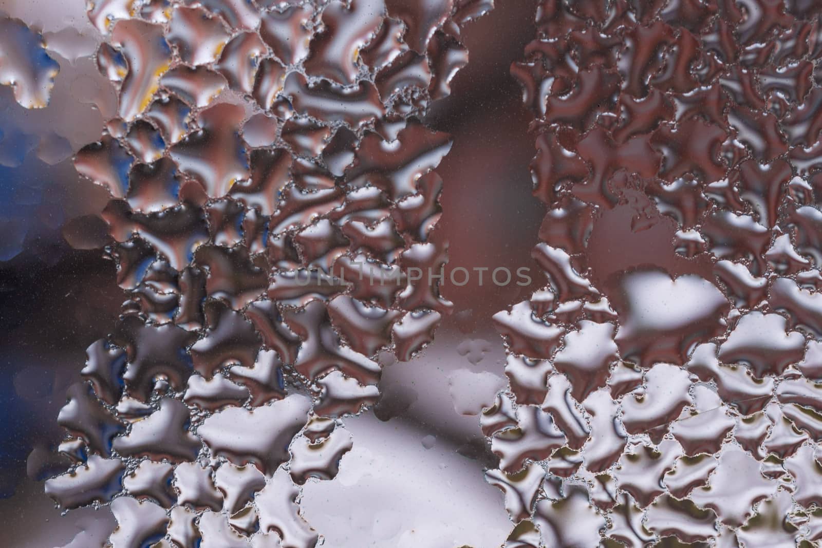 Water drops on glass window close up with blurred background. Drops in macro. Condensate on window closeup. Wet air.