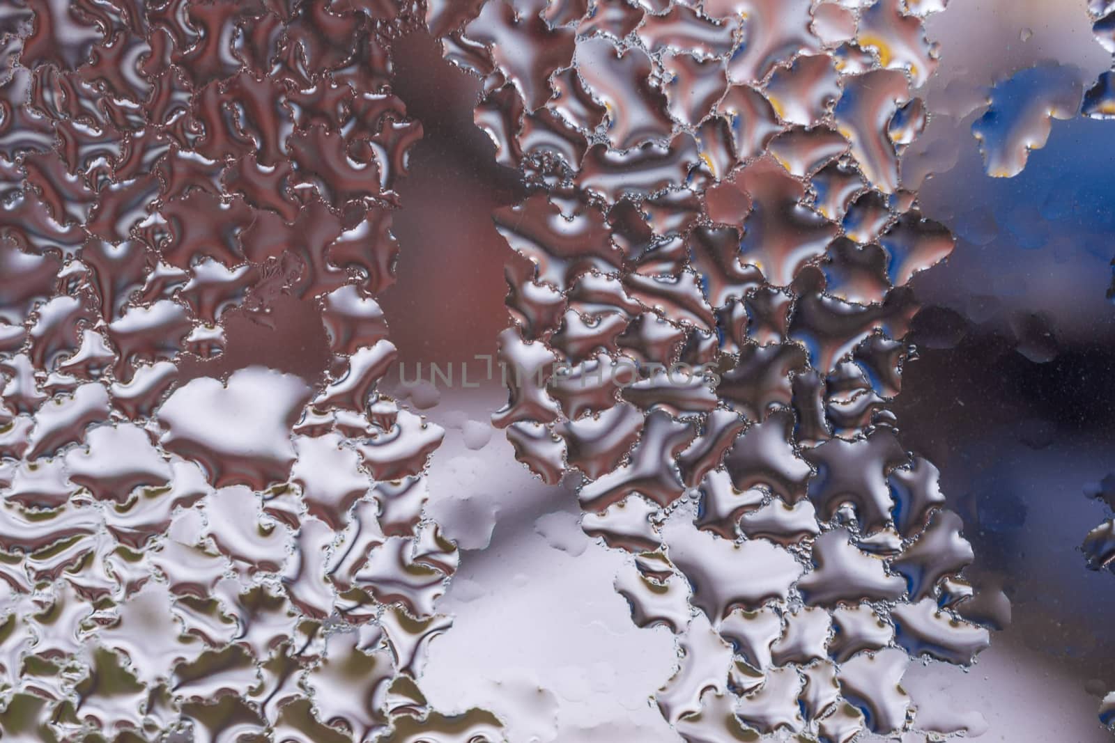 Water drops on glass window close up with blurred background. Drops in macro. Condensate on window closeup. Wet air.