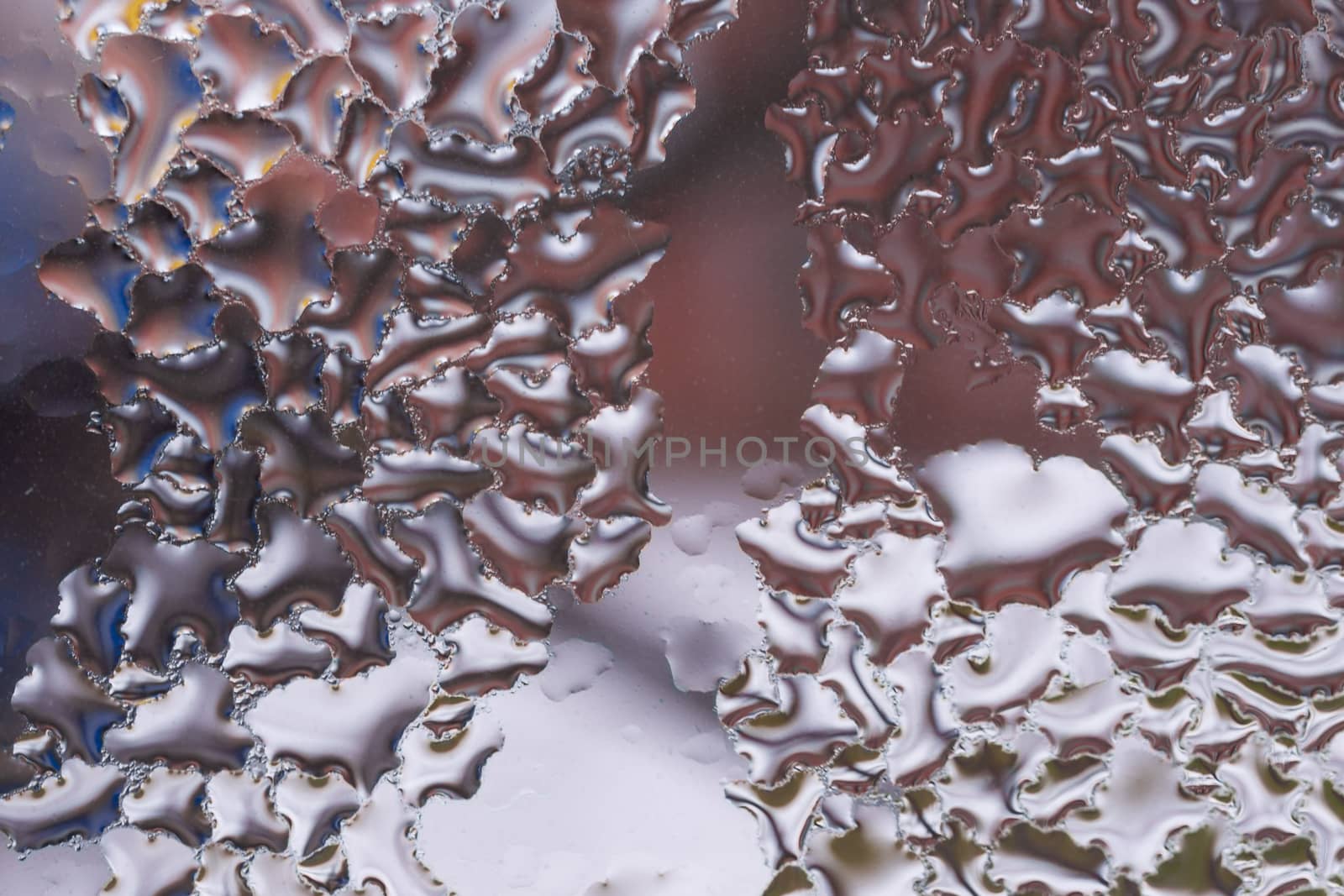 Water drops on glass window close up with blurred background. Drops in macro. Condensate on window closeup. Wet air.