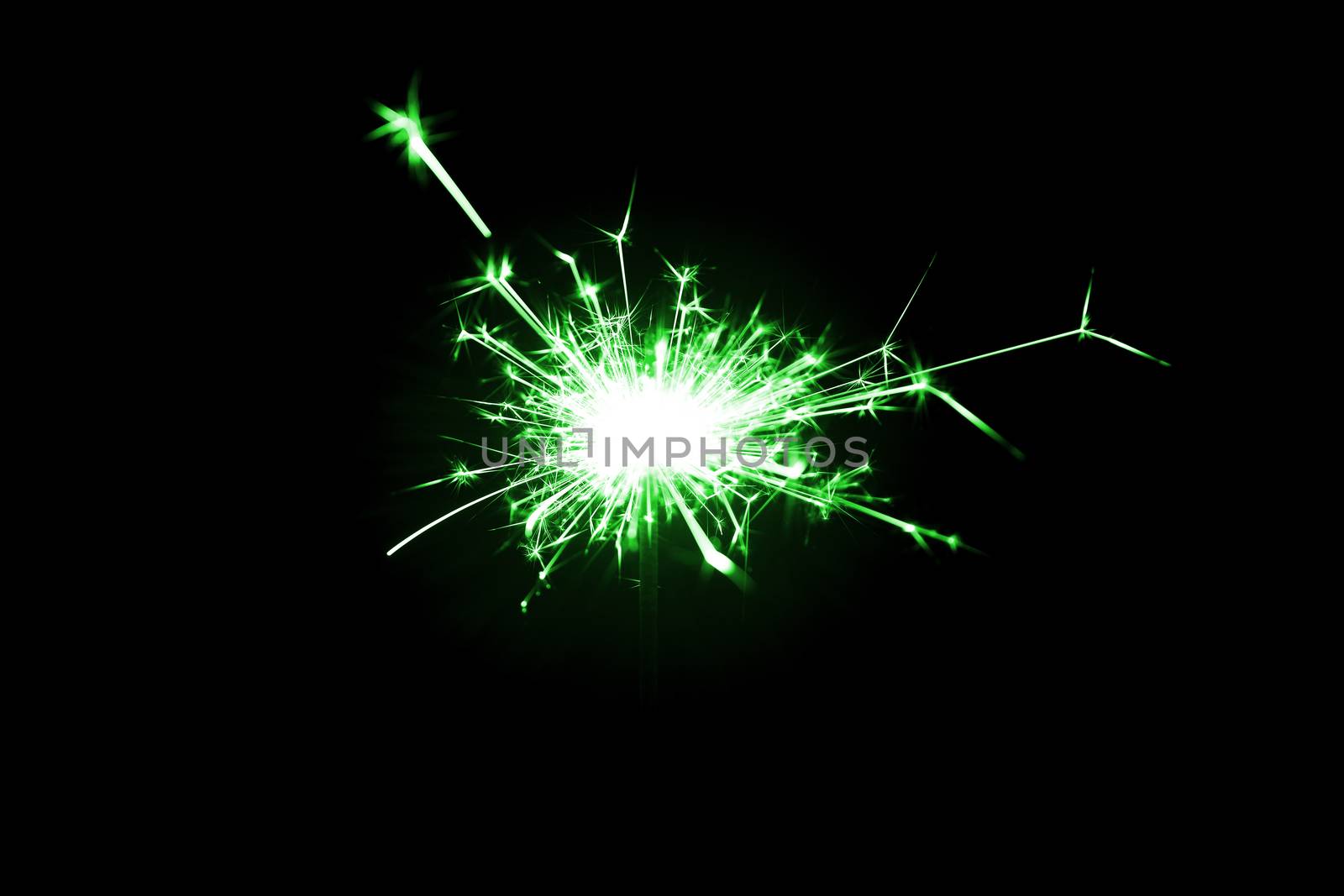 Low light photo of bengali fire isolated on black background with green toning. A lot of light and sparks. Underexposed photo.