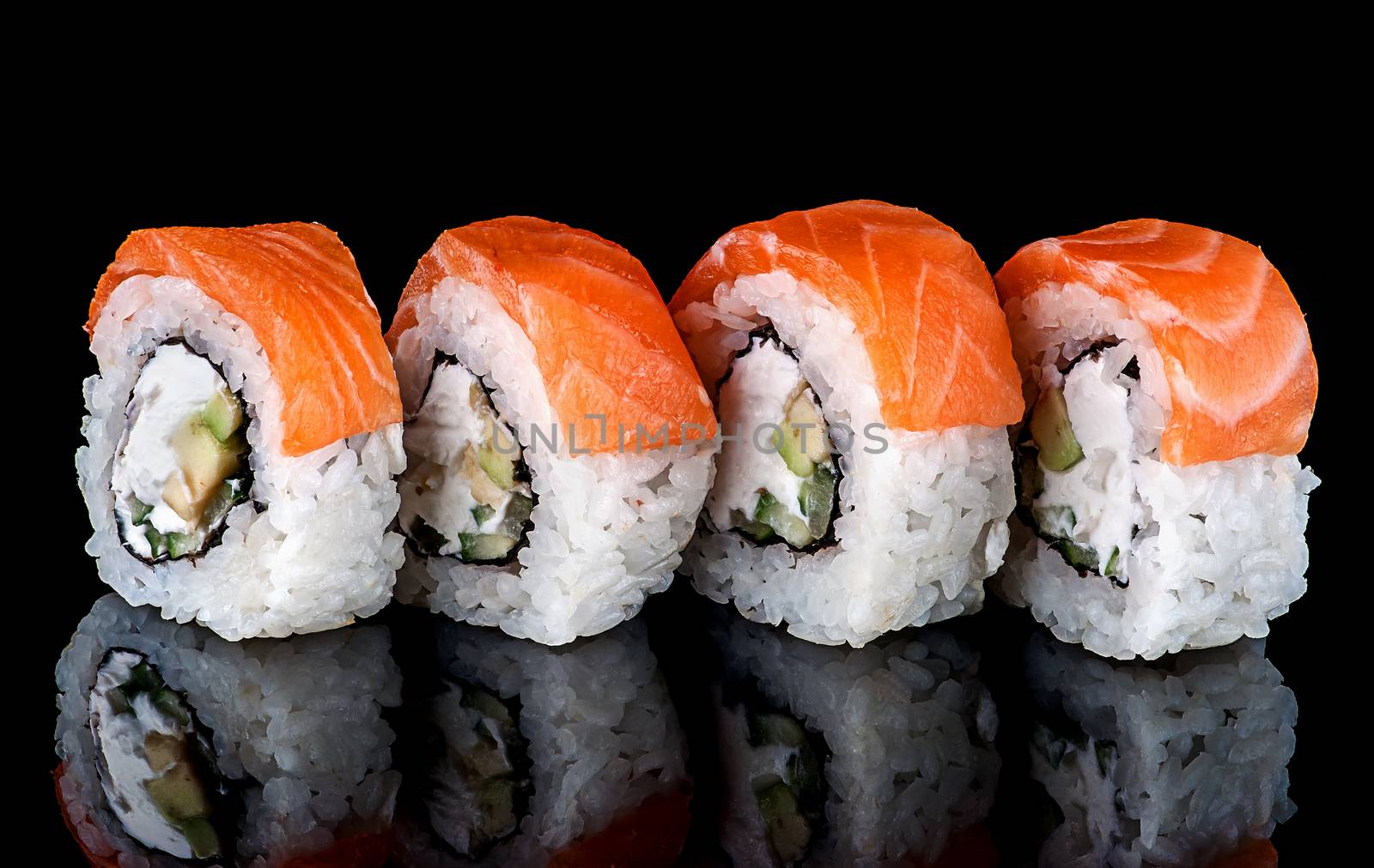Sushi roll Philadelphia in row rotated. Black background with reflection.