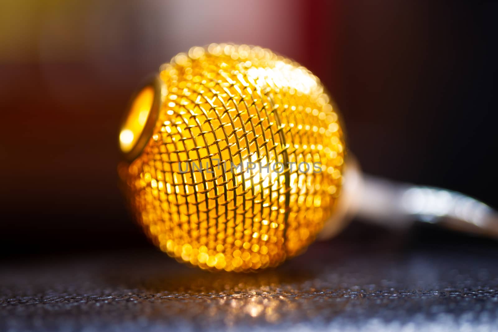 Battery garland with metallic grid balls on blurred background. Closeup view.