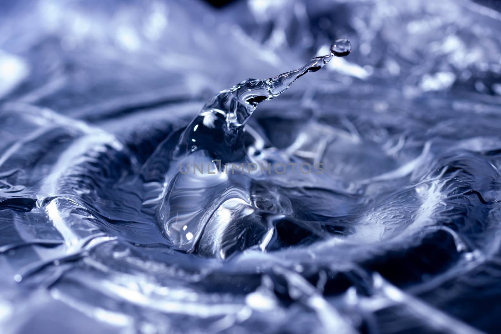 Water drops splashing on acoustic membrane. A lot of drops in air. High frequency of sound waves. Water cloud small drops. Frozen time shot.