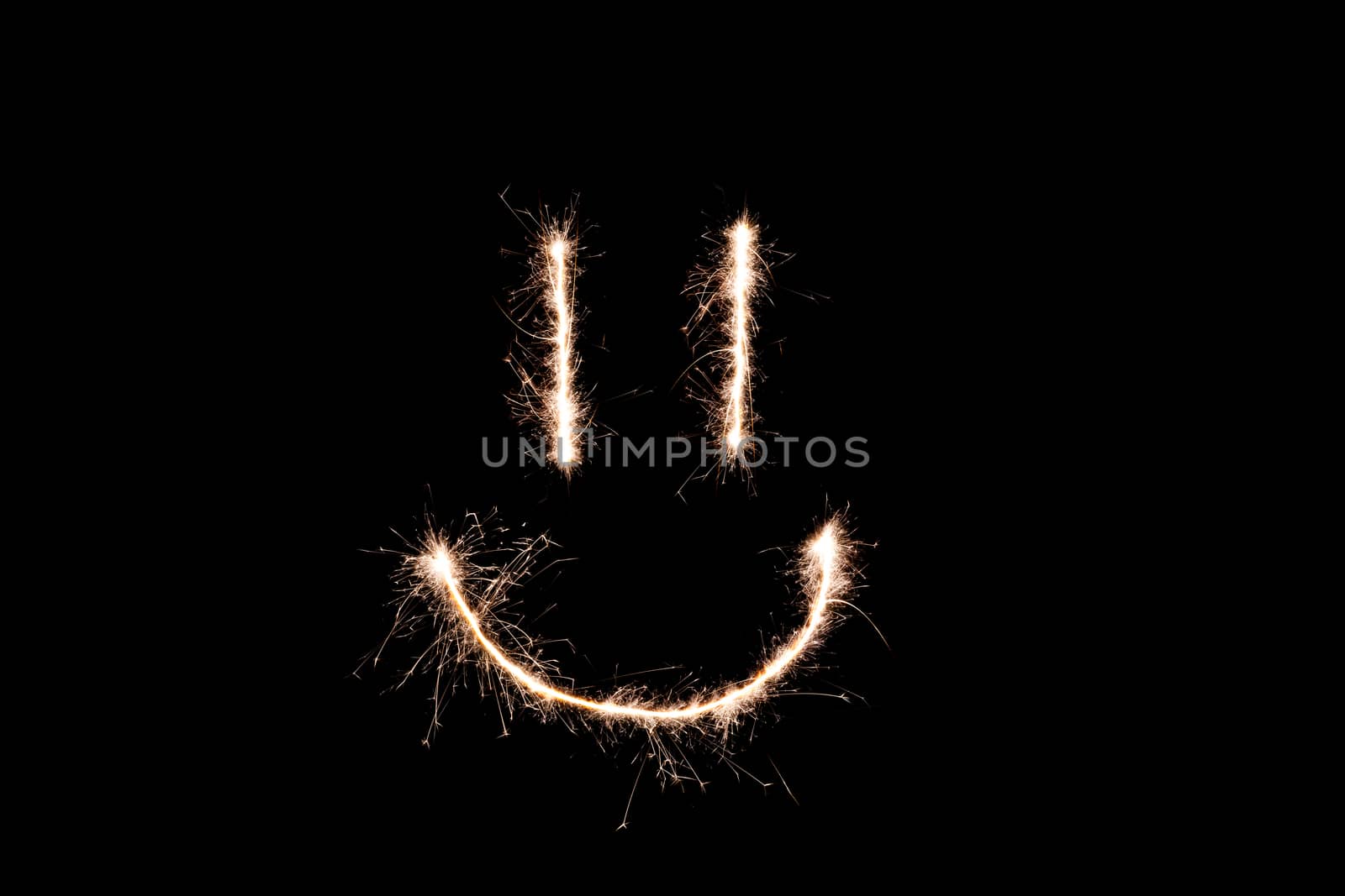 Long exposure underexposed photo of lightpainting bengali fire. Lighdrawing photo. Soft focus and a lot of lines. Smile on photo
