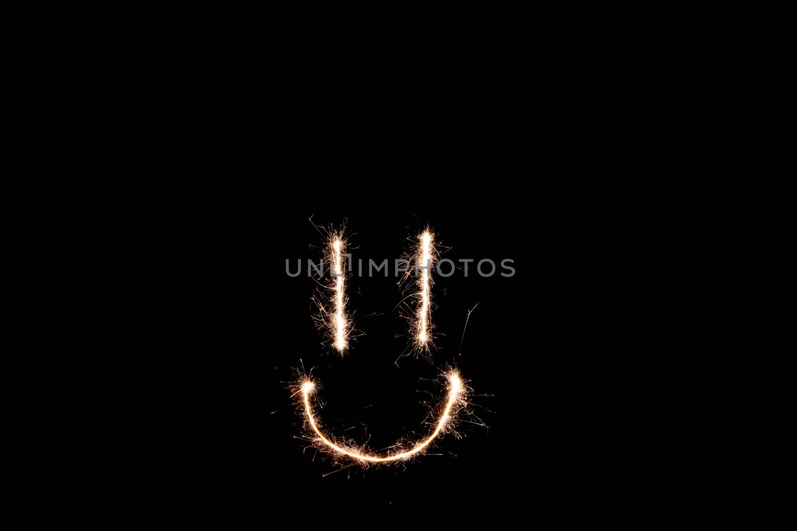 Long exposure underexposed photo of lightpainting bengali fire. Lighdrawing photo. Soft focus and a lot of lines. Smile on photo
